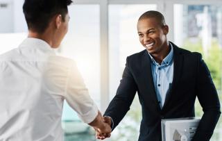 Man shaking hands of colleague